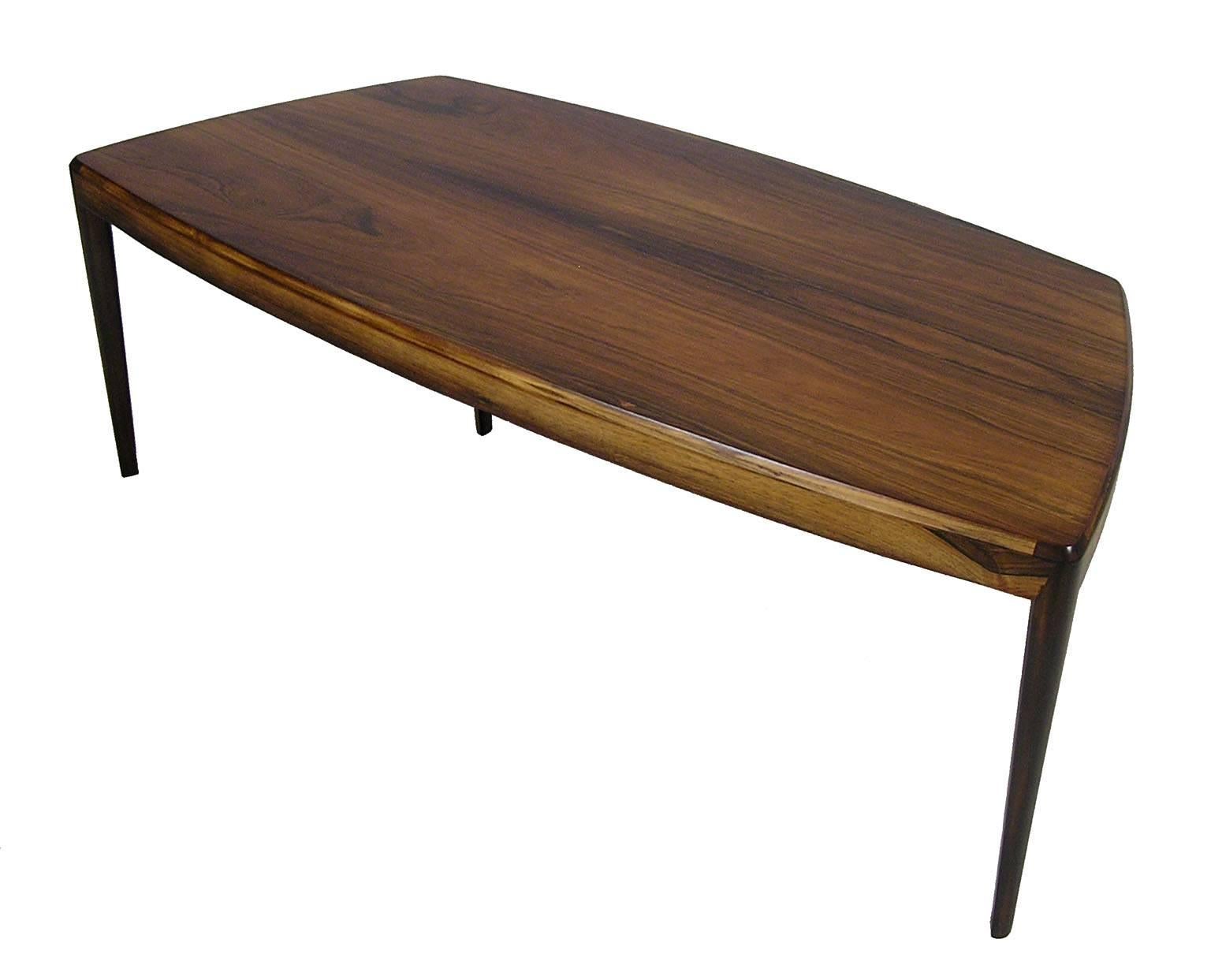 A gorgeous Brazilian rosewood coffee table from the 1960s Danish modern era. Designed by Kai Kristiansen and in excellent newly refinished condition. Amazing craftsmanship throughout featuring a stylish curved biomorphic profile and beautifully