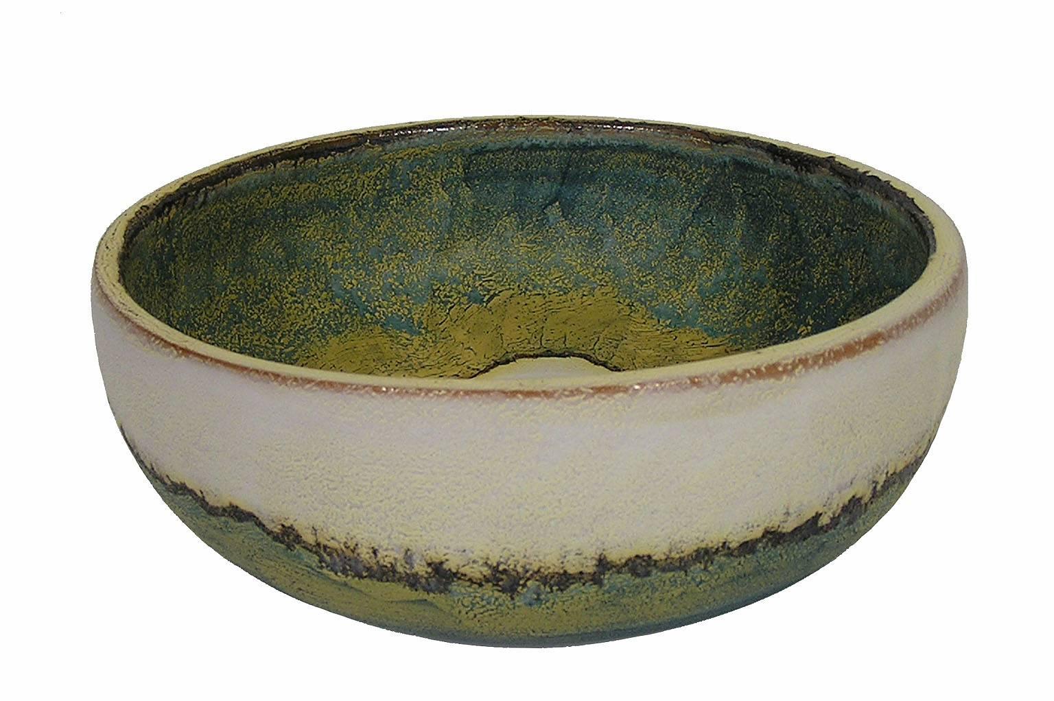 A ceramic pottery bowl from the 1970s by Marcello Fantoni of Italy. Decorated throughout using in multi-toned matte and semi-matte glaze and featuring a beautifully patterned interior. Bowl is signed on the bottom and in excellent condition.