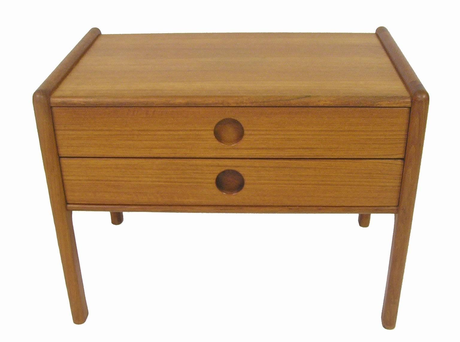 A beautiful two-drawer teak chest from the 1960s Danish modern era. Designed by Kai Kristiansen for Vildbjerg Mobelfabrik of Denmark. Stylish compact size with inset elliptical pulls and dovetailed drawer joinery. A Classic example of Scandinavian