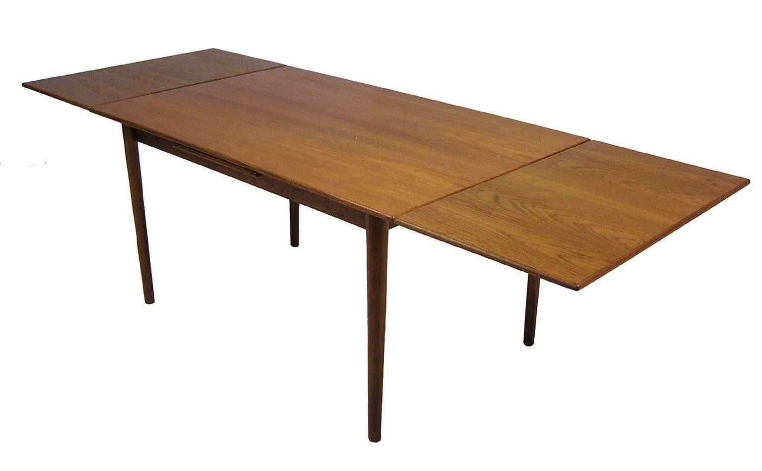 A gorgeous teak draw-leaf dining table from the 1960s by Borge Mogensen for Sorborg Mobler of Denmark. Classic Scandinavian Modern era lines and compact expandible form. Features a pair of 19 5/8