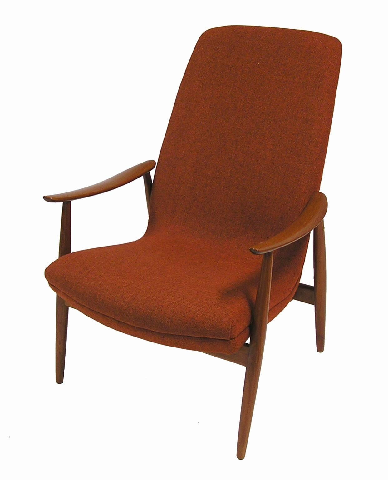A stylish teak lounge chair designed by Ingmar Relling for Westnofa of Norway. Gorgeous Scandinavian Modern era lines with beautifully crafted armrests and removable head cushion. Newly re-foamed but retaining the original rust colored fabric and in