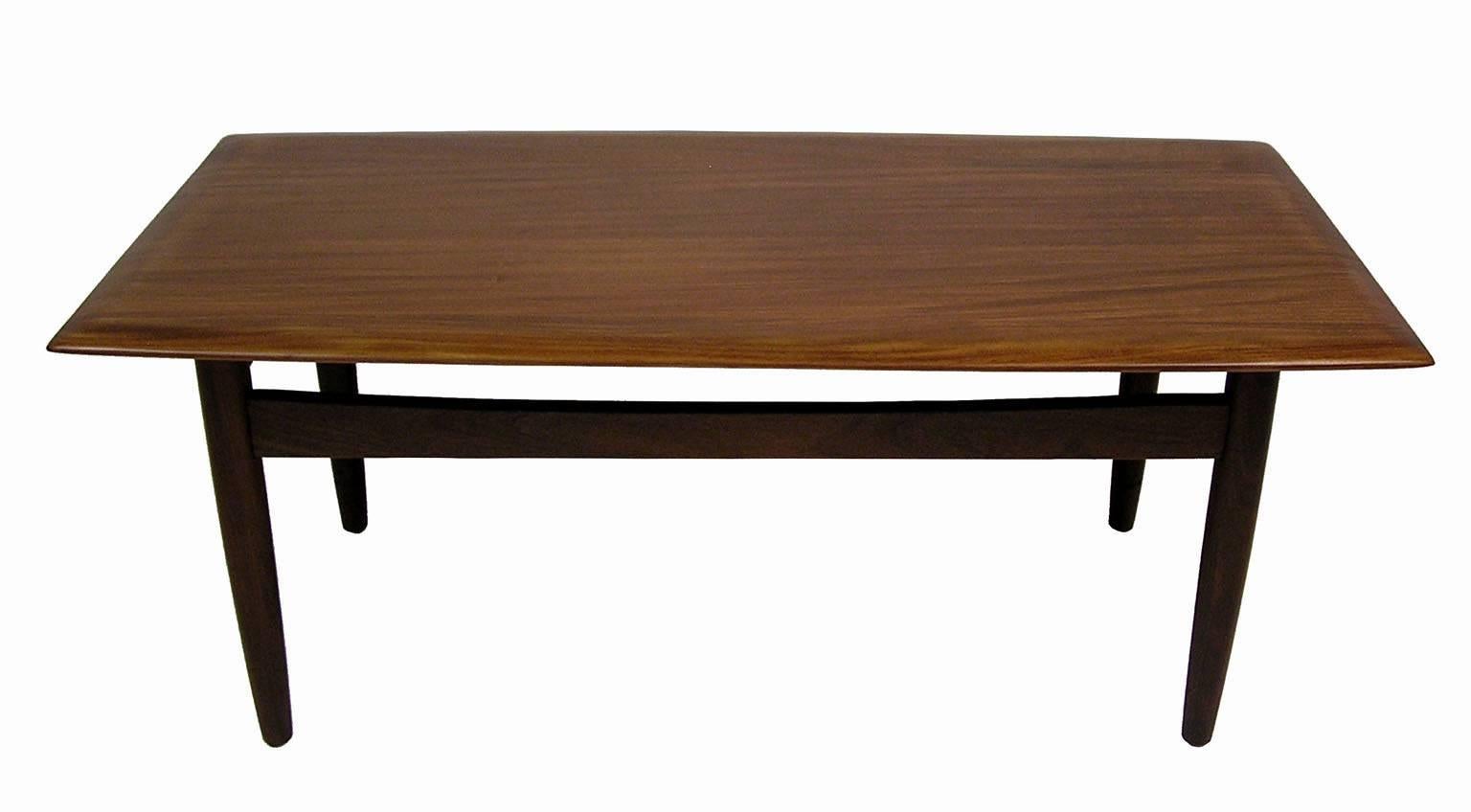 A stunning solid teak coffee table from the 1960s Mid-Century Modern era designed by Jan Kuypers for Imperial Stratford of Canada. Amazing Danish Modern inspired craftsmanship throughout featuring a solid teak top with a tapered edge and conical