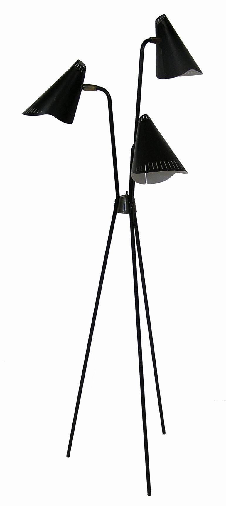 A rare 1950s tripod-leg floor lamp designed by Gerald Thurston for Lightolier. Lamp features three articulating lamp heads that can be lit up individually or simultaneously. This item is newly rewired including new sockets and cord. Overall