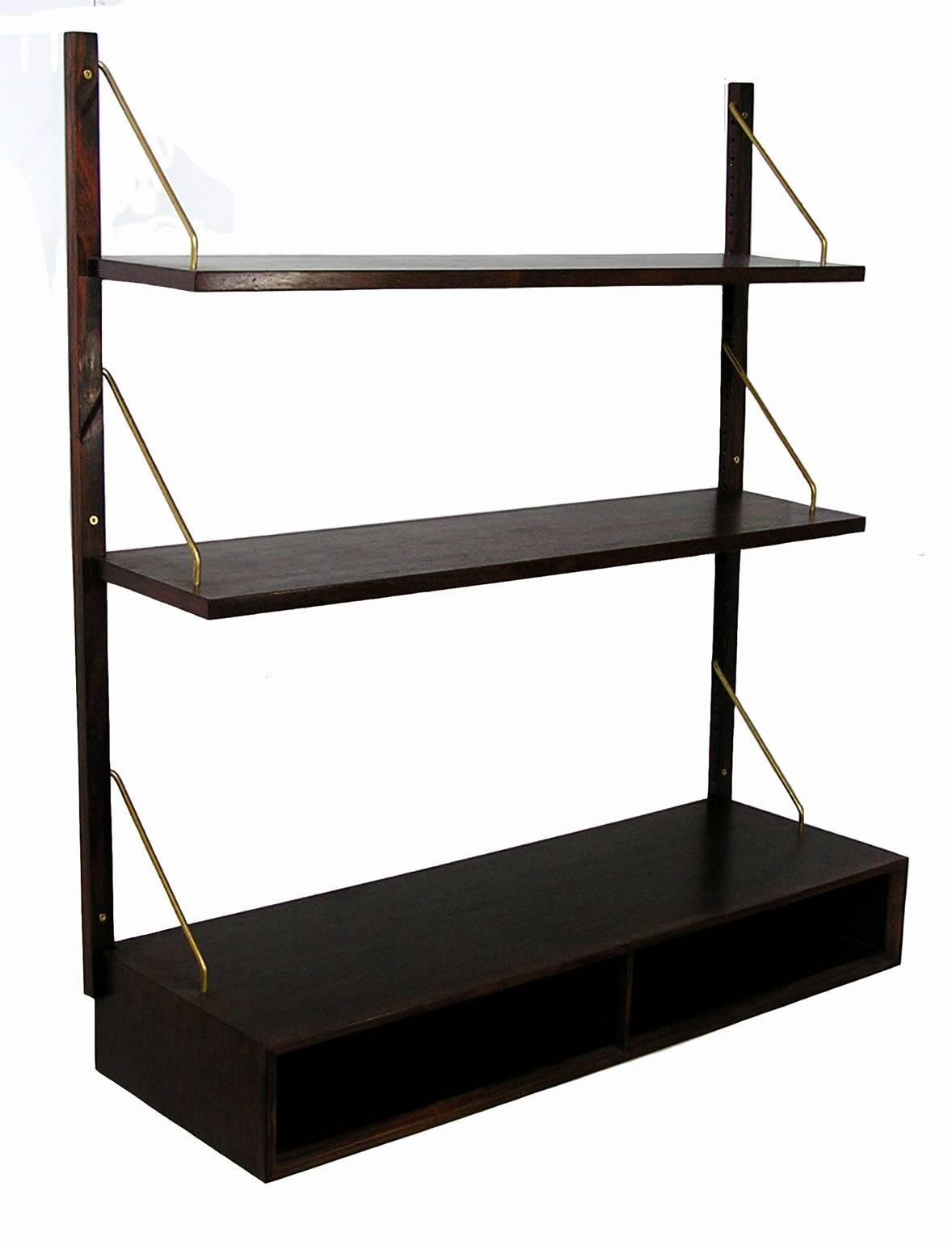 A gorgeous single section rosewood Royal System wall-mount shelving unit from the 1950s designed by Poul Cadovius for Cado of Denmark. Stylish compact form with two 9 1/4