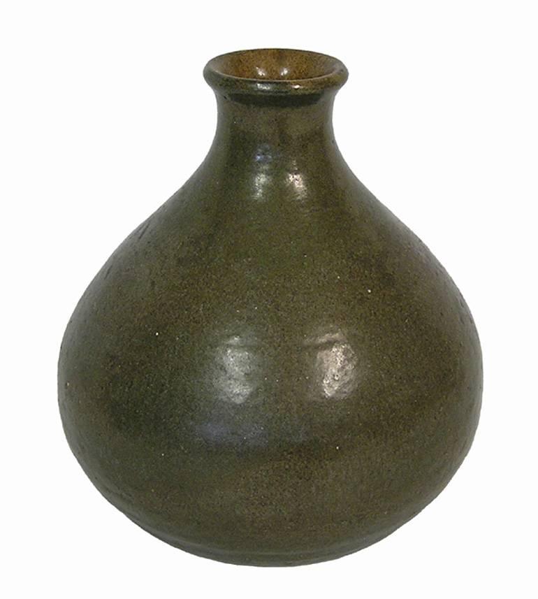 A gorgeous handcrafted stoneware pottery bud vase from the 1960s Danish Modern era. Beautiful craftsmanship throughout featuring a bulbous form with tapered neck. Decorated in an organic olive green glaze with matte black patterning to one side and