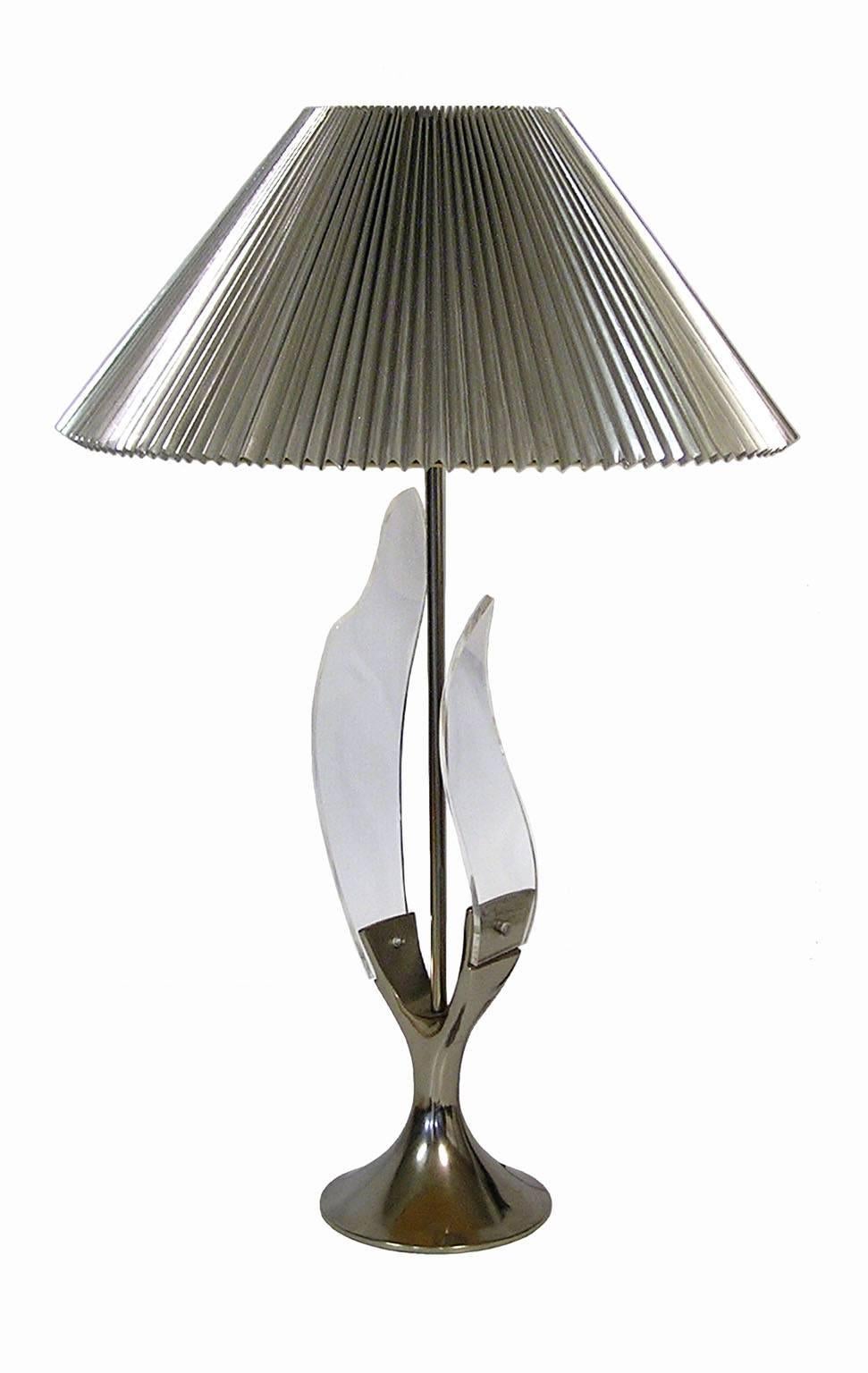 A stunning chrome and Lucite table lamp from the 1970s designed and produced by the Laurel Lamp Company. Features a polished chrome 