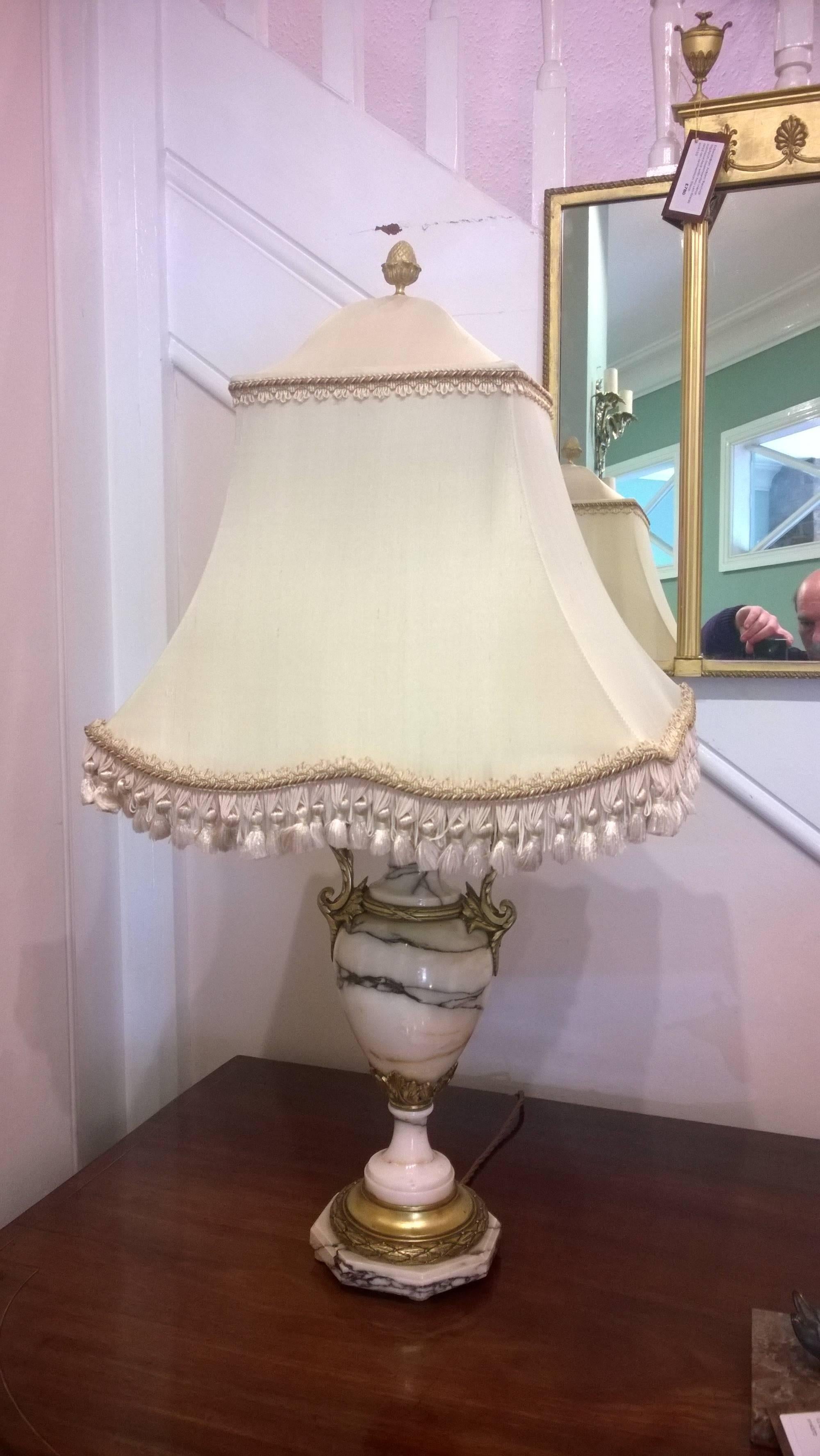 Pair of Victorian Carrara marble and gilt metal decorated urns converted to electric lamps - all lights and lamps have been rewired with authentic corded flex, fitted with either foot switch or finger clicker switch and are Pat tested. Measures: 16