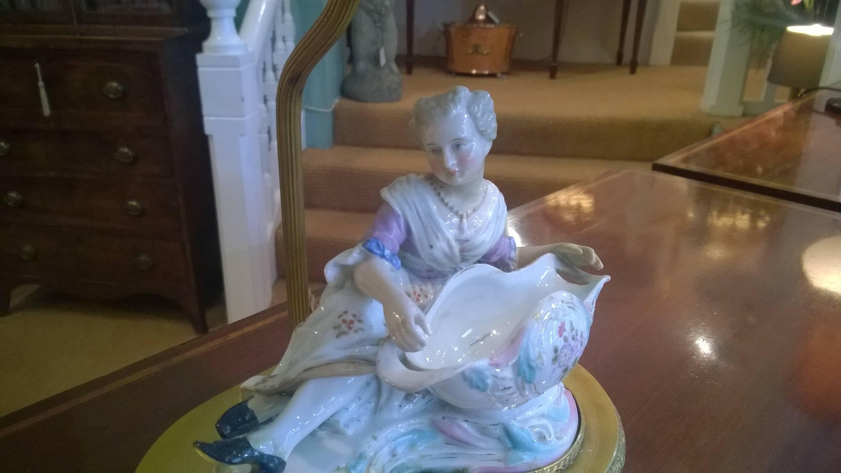 Porcelain Table Lamp in the form of a reclining female figure on an oval brass base with shade - all lights and lamps have been rewired with authentic corded flex, fitted with either foot switch or finger clicker switch and are Pat tested. Measures: