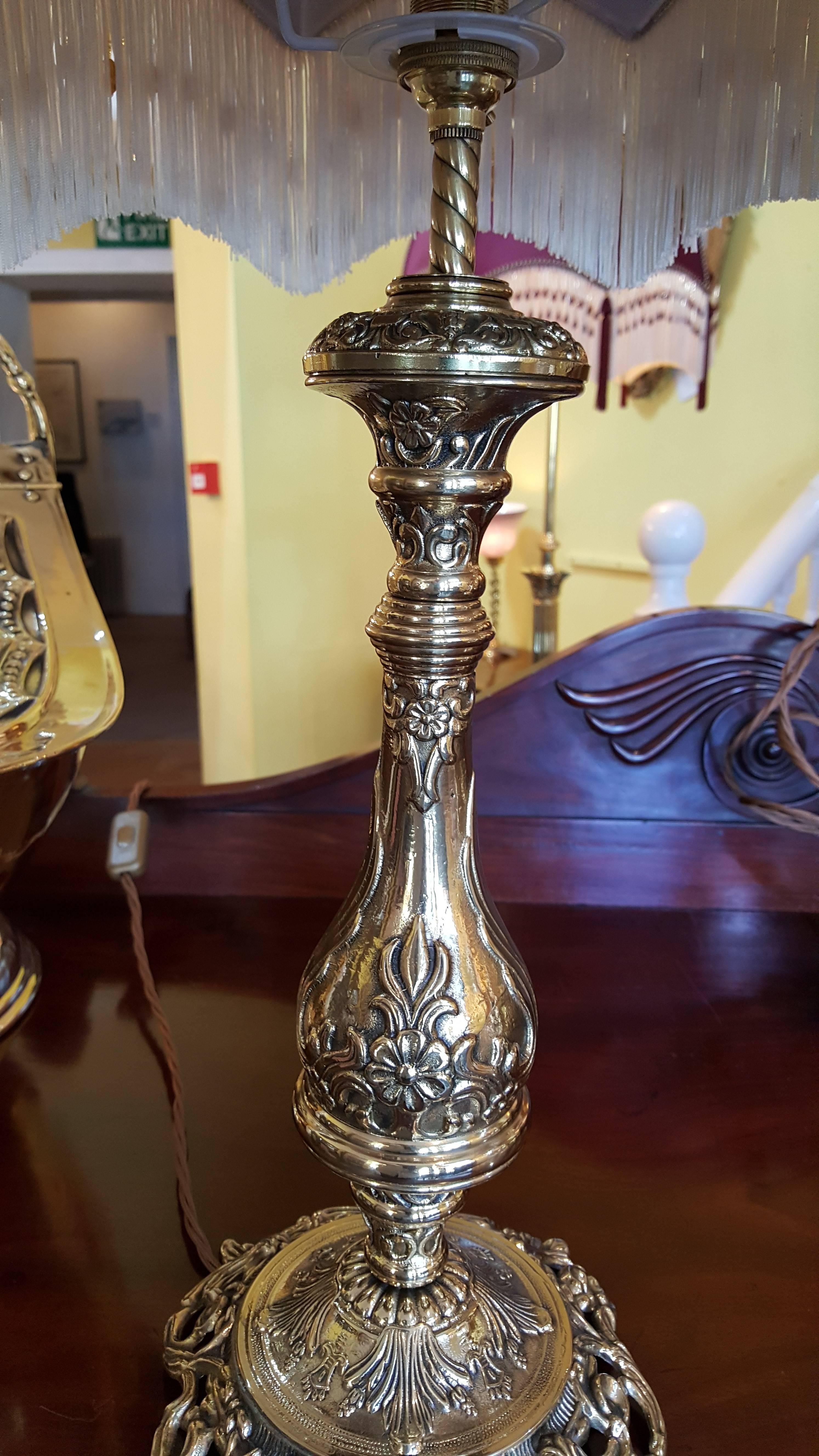 A pair of lacquered brass table lamps, cast with flowers and scrolls, circa 1930s
The lampshade(s) are newly handmade silks by the same maker as provides the shades for Downton Abbey - all lights and lamps have been rewired with authentic corded