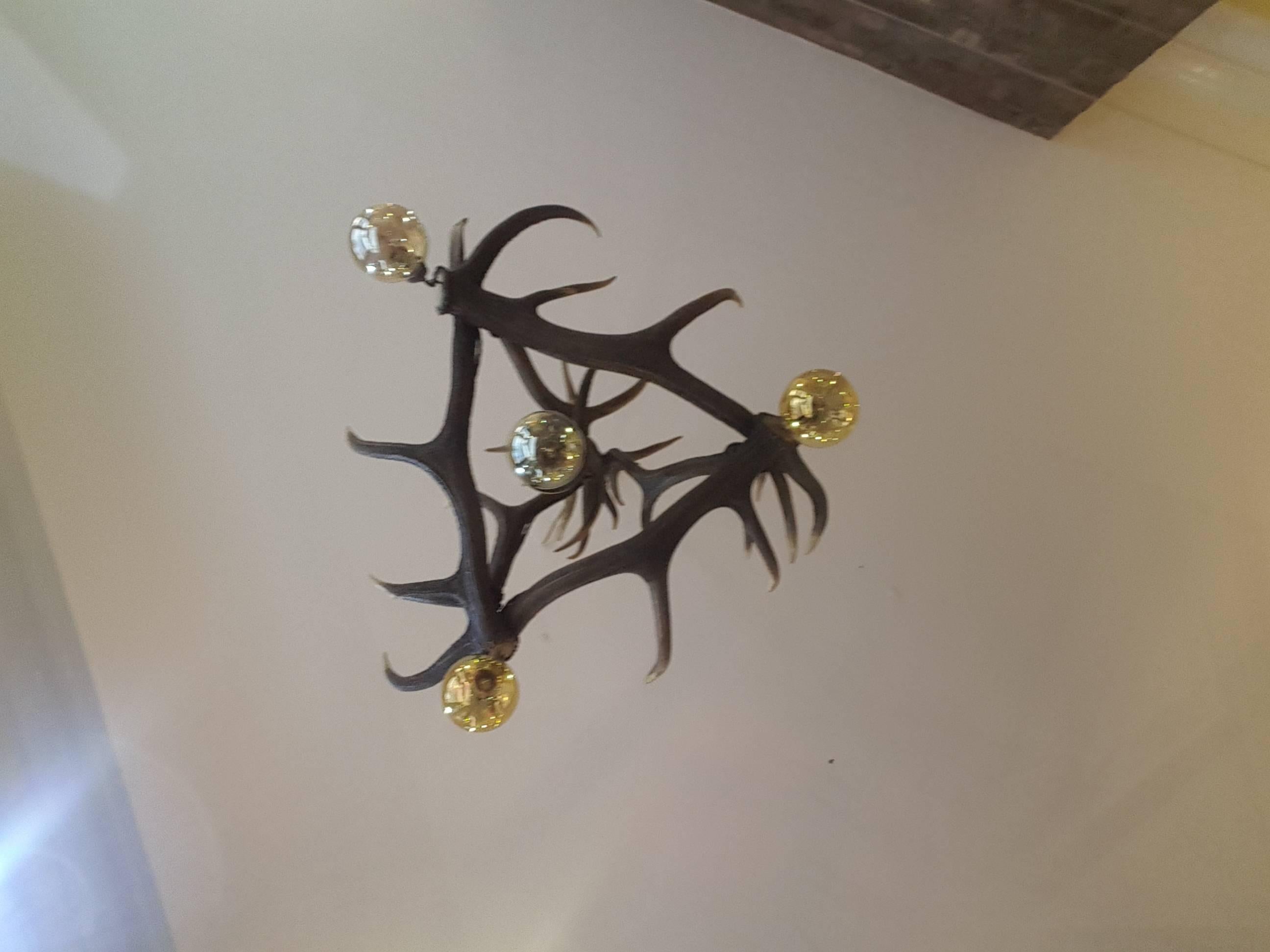 An Austro-German Red Deer Antler Mounted Chandelier, constructed from eight
shed antlers, fitted with a central light fitting and three other light fittings to the outer antlers c1930
33
