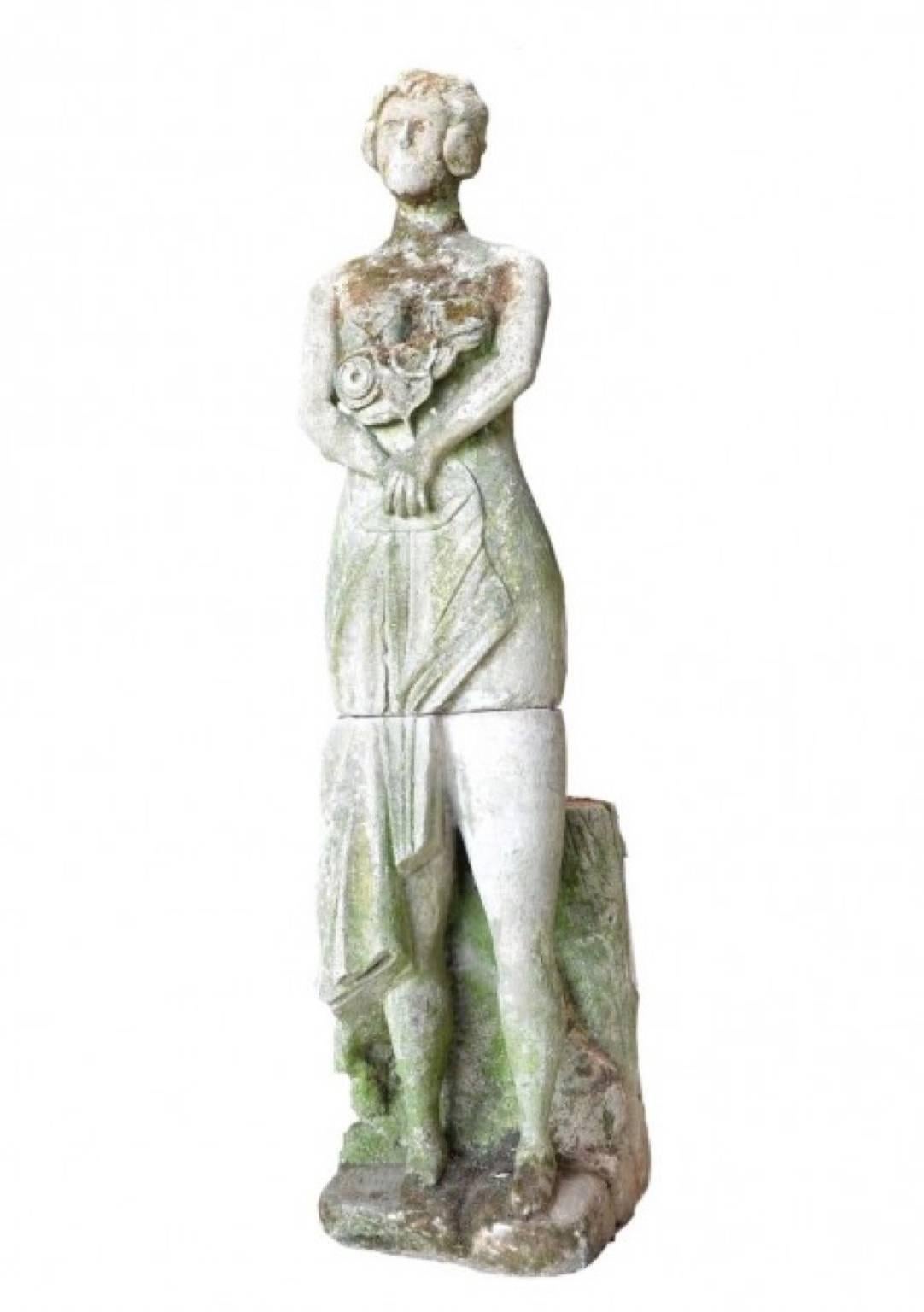 French limestone statue of lady holding flowers.
 