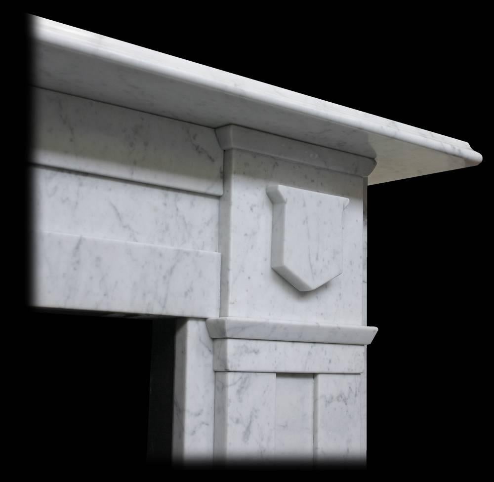 Antique early Victorian Carrara marble fireplace surround with recessed panel legs and carved shield capitals,
circa 1840.
Measures:
Shelf length 74
