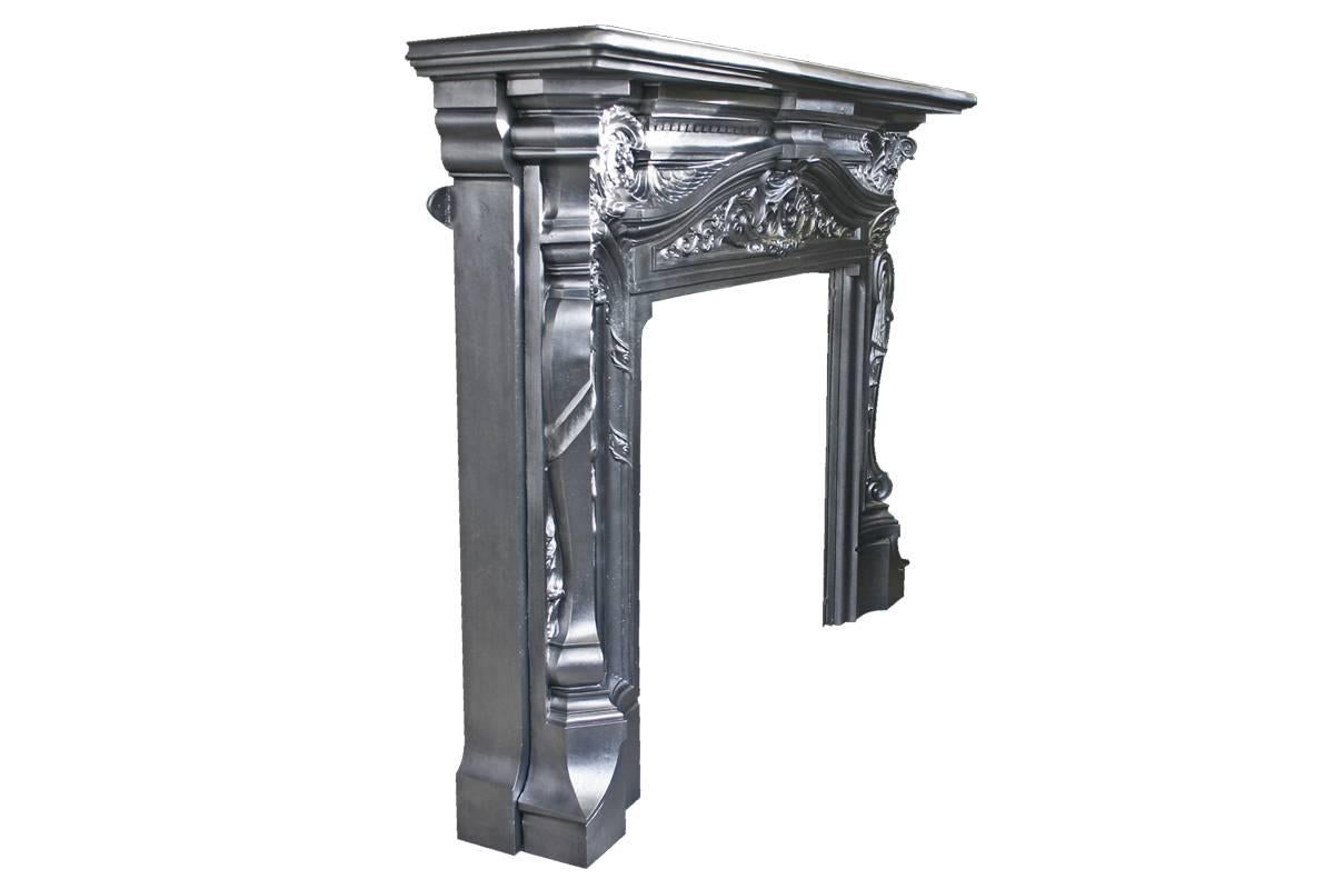 Spectacular reclaimed antique late Victorian cast iron chimneypiece in design, proportion and quality of casting. The deep bow fronted shelf sits above a breakfront cornice detailed with dentil mouldings, above a sweeping frieze decorated with