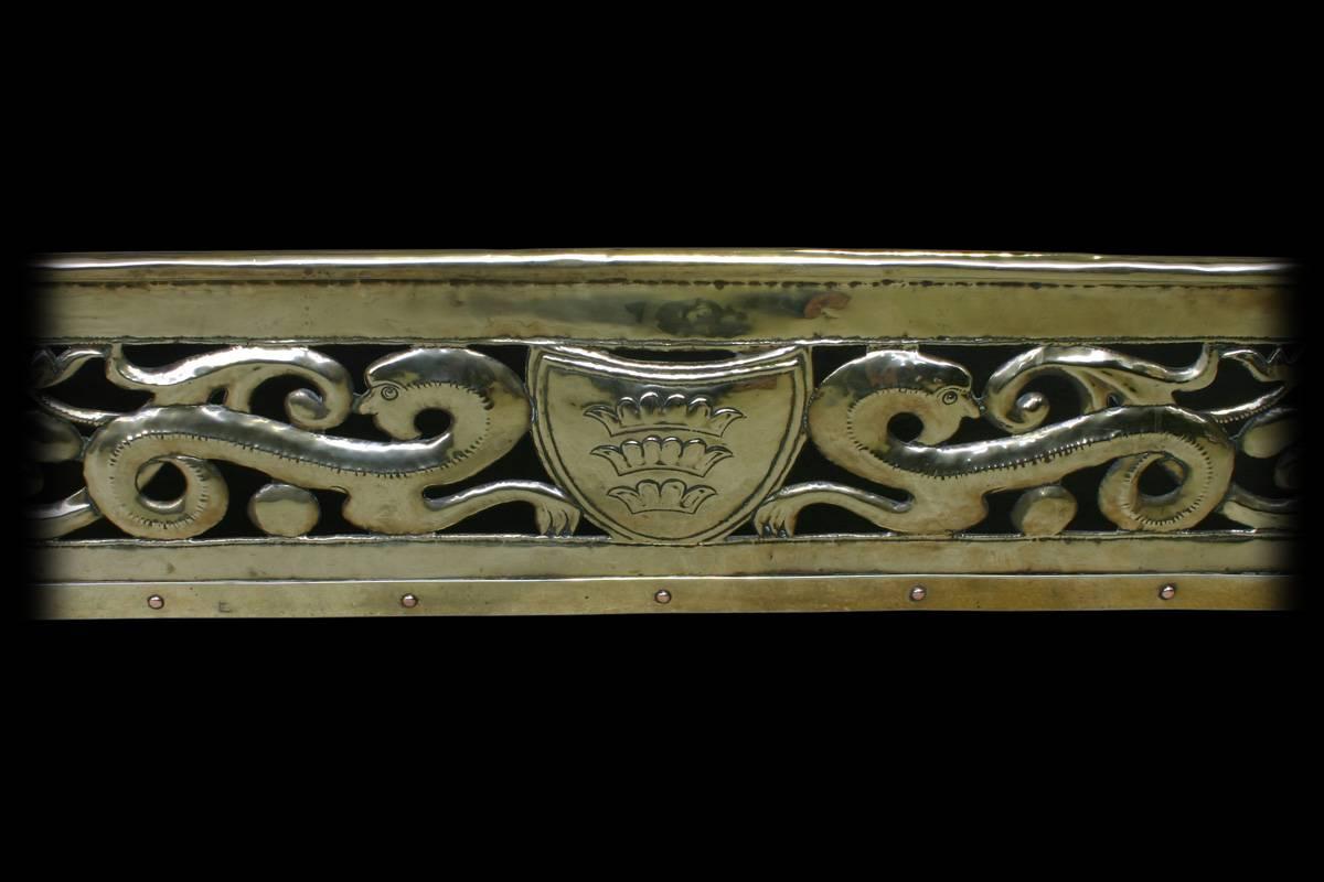 Large reclaimed Victorian Arts and Crafts brass fender decorated with pierced repoussee work. In the manner of John Pearson, circa 1890.