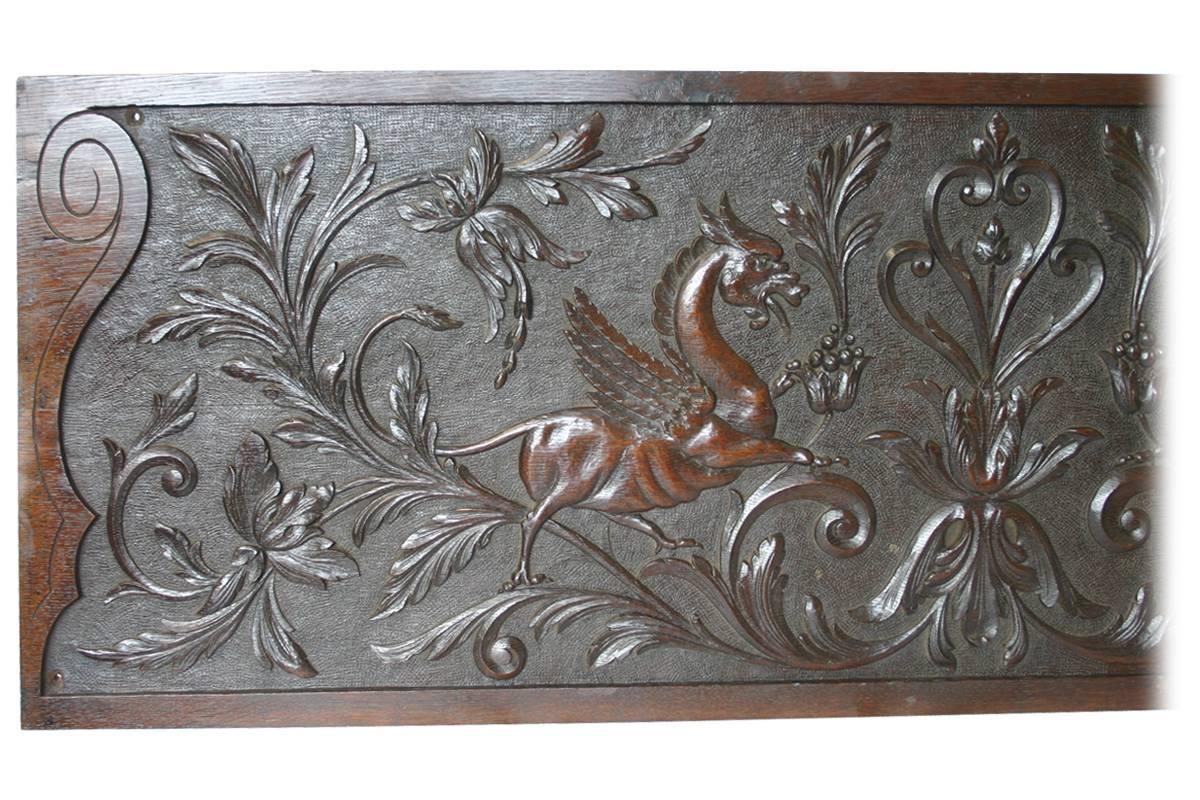 Large 19th century carved oak panel depicting winged mythical beasts amongst scrolling foliage. Excellent condition and color throughout. Four countersunk holes in each corner from a previous installation.
Measures: 133.5cm wide x 44.5cm high x