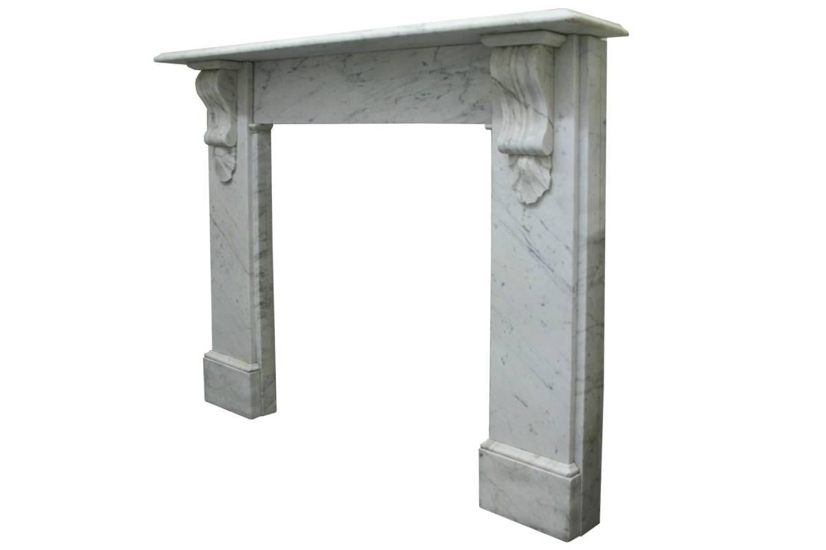 Reclaimed Victorian Carrara marble fireplace surround with classically carved corbels supporting the shelf, circa 1880.
Images prior to restoration. This chimneypiece is awaiting restoration, please enquire as to the lead time to complete the