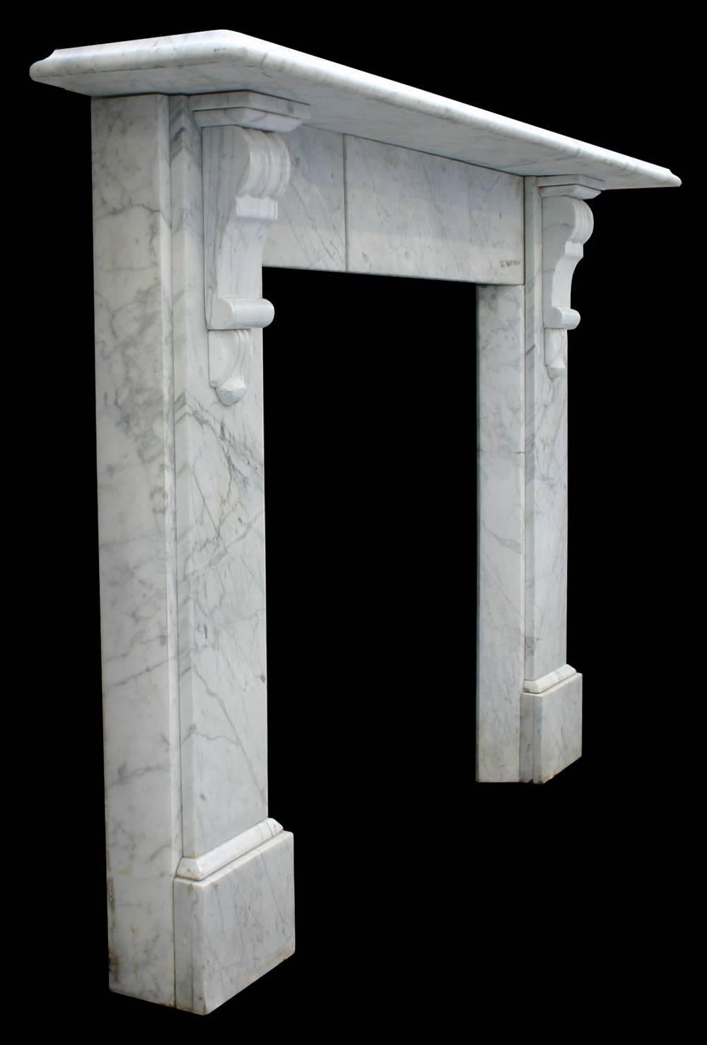 Antique late Victorian Carrara marble fire surround with fluted corbels supporting the shelf.

Images prior to restoration. This chimneypiece is awaiting restoration, please enquire as to the lead time to complete the restoration before ordering.