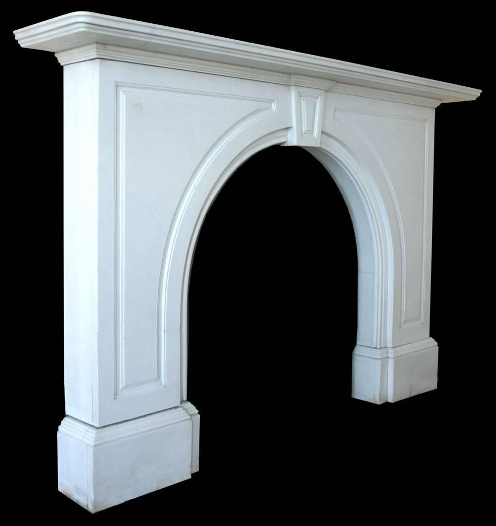A late Victorian antique statuary white marble fireplace with an arched aperture, the spandrels are decorated with fielded panels as is the keystone. Removed from a fine property in Malvern, Worcestershire, circa 1870.