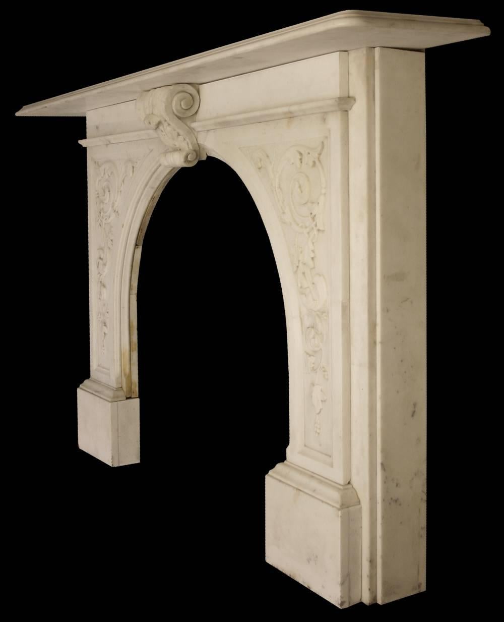 A substantial antique Victorian carved statuary marble fire surround with arched aperture. Each leg is well carved with acanthus scrolls, so too is the large keystone.

Images prior to restoration. This chimneypiece is awaiting restoration, please