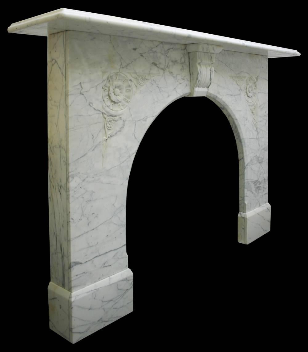 Antique Victorian white Carrara marble fire surround with an arched aperture and carved flowers in the spandrels.
For detailed sizes please see final image.