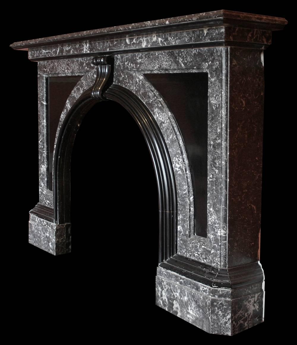 Very large late Victorian St Anne marble fire surround with an arched aperture, the spandrels are filled with black marble panels and the whole is decorated with extravagant black marble mouldings. English, circa 1890.

Images prior to