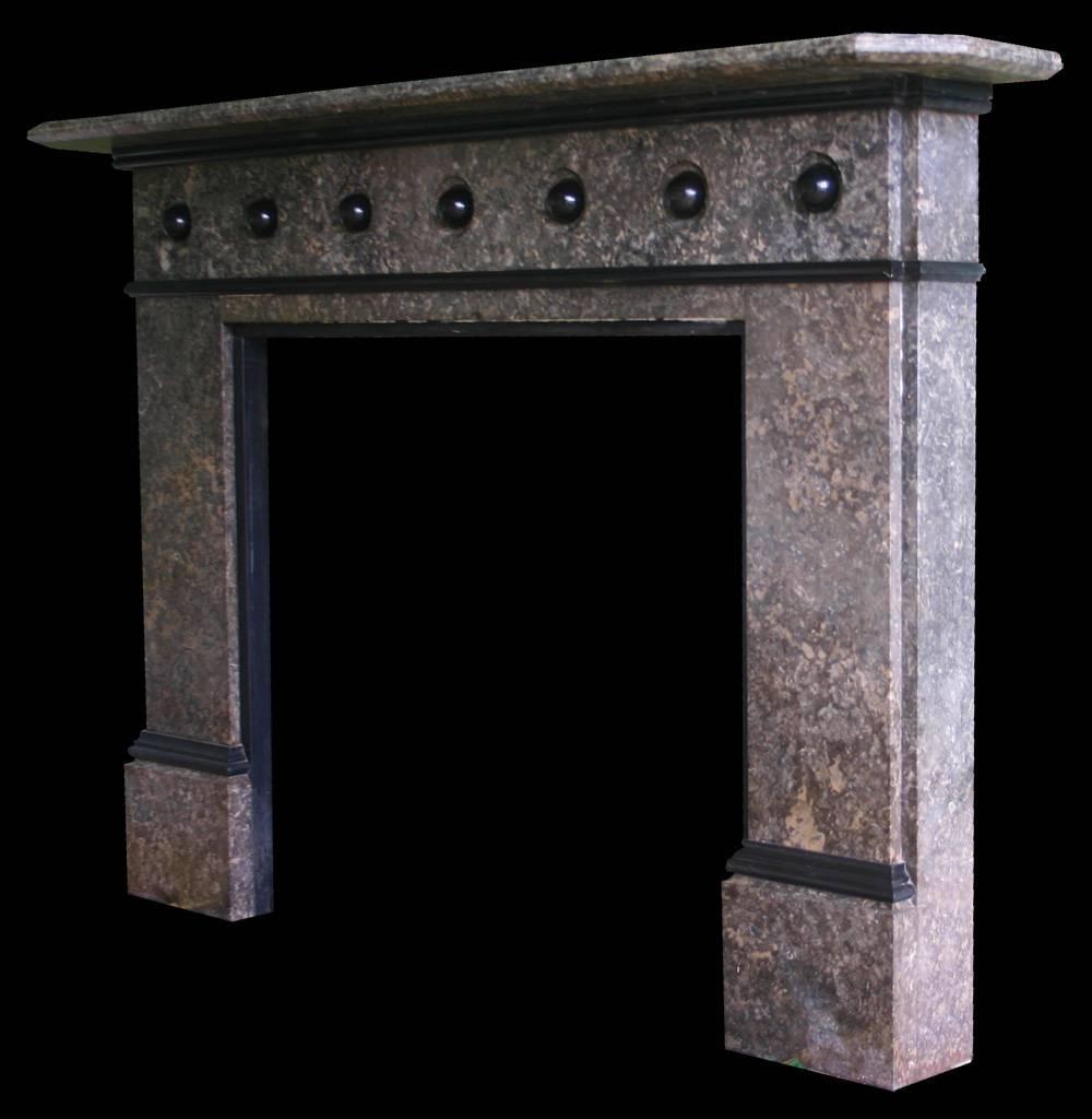 Large late Victorian Derbyshire limestone fire surround. The frieze decorated with black marble bosses.

Images prior to restoration. This chimneypiece is awaiting restoration, please enquire as to the lead time to complete the restoration before