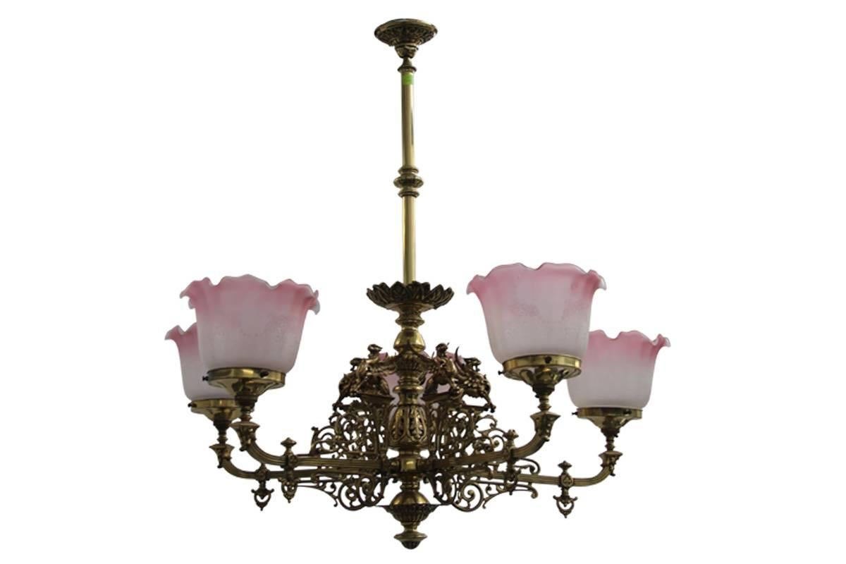 Ornate antique 19th century five branch brass chandelier, complete with replacement frosted and cranberry shades.
Overall 880mm drop x 850mm wide.