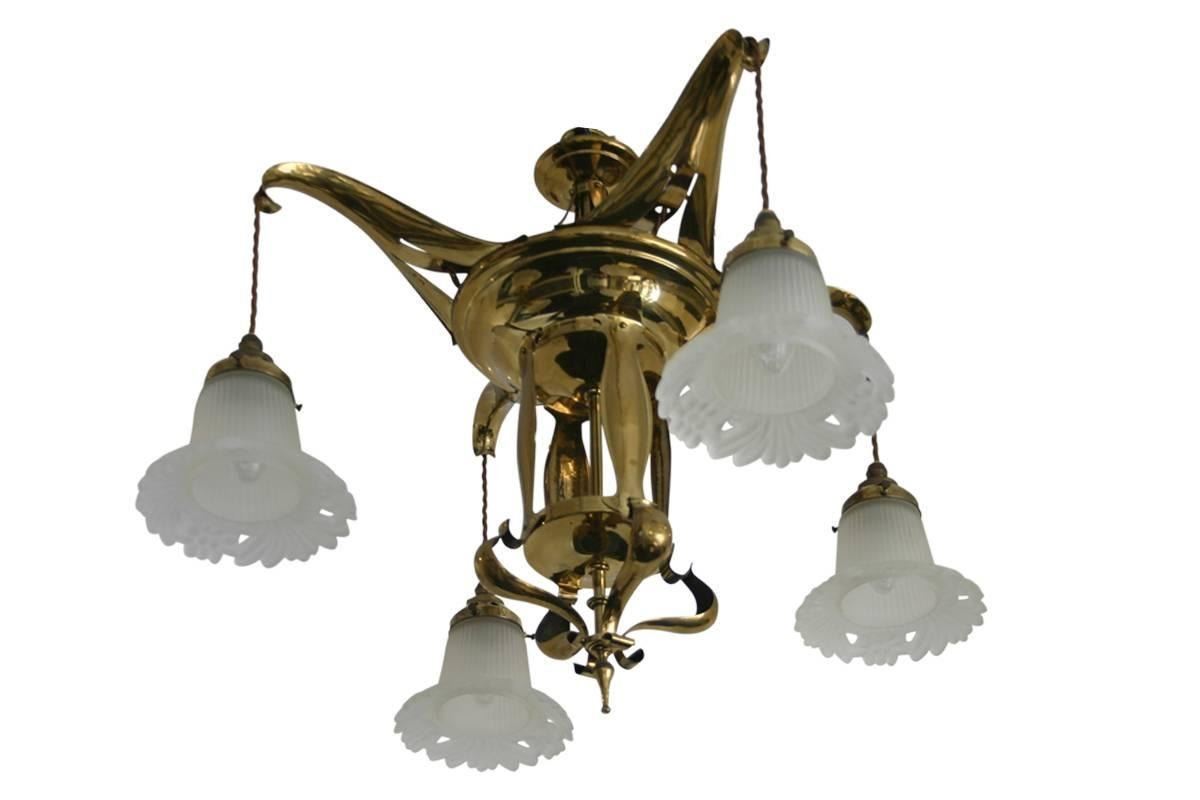 Edwardian Art Nouveau brass four branch ceiling light, circa 1900. Complimented by replacement frosted glass shades.
Fully rewired and PAT tested.
Measures approximately 60cm high and chain and rose by 64cm wide.