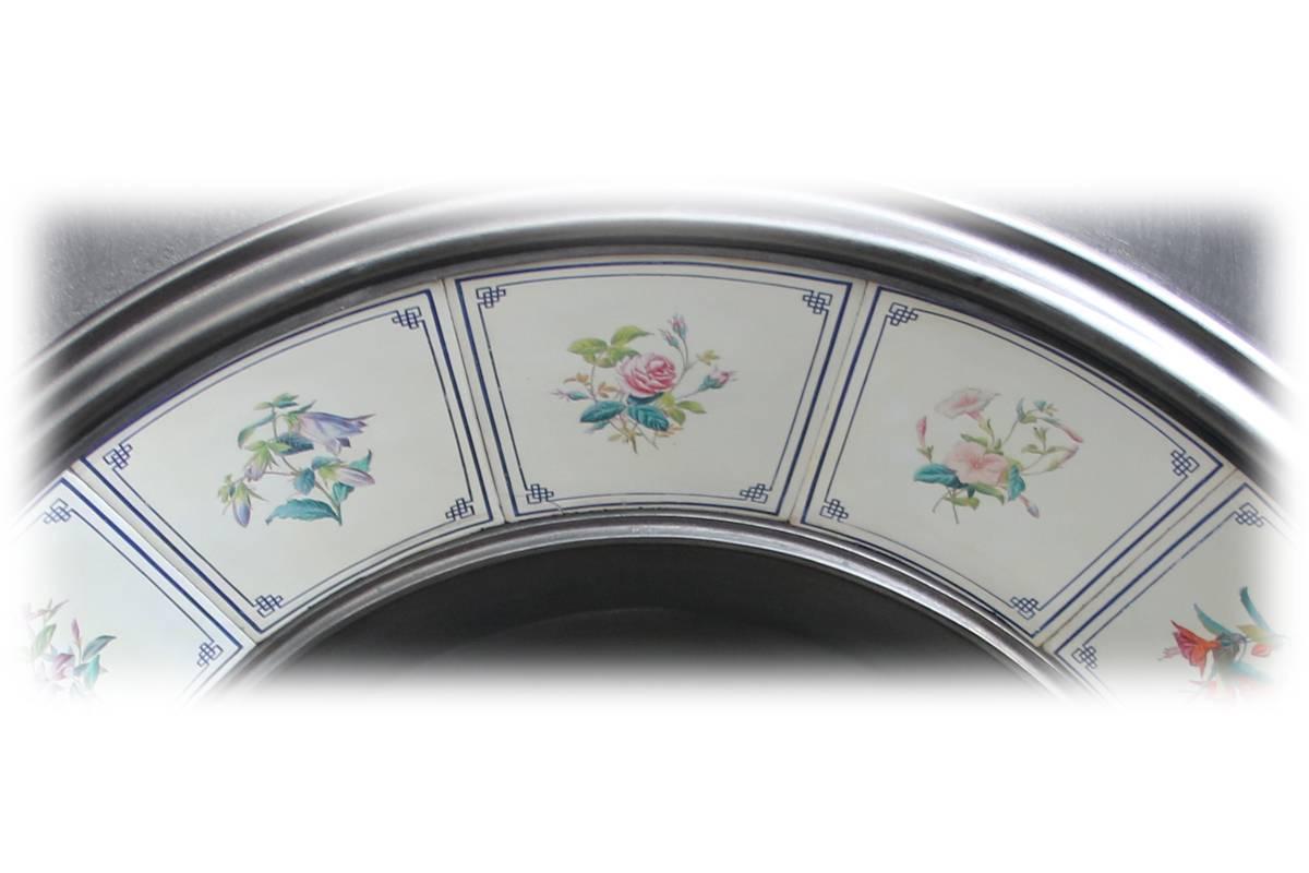 Rare large antique Victorian arched fireplace grate of simple form with beautiful hand-painted floral porcelain tiles in the manner of Copland or Maw & co, circa 1870.
Some rubbing to the tiles, namely on the blue border where the fireplace has