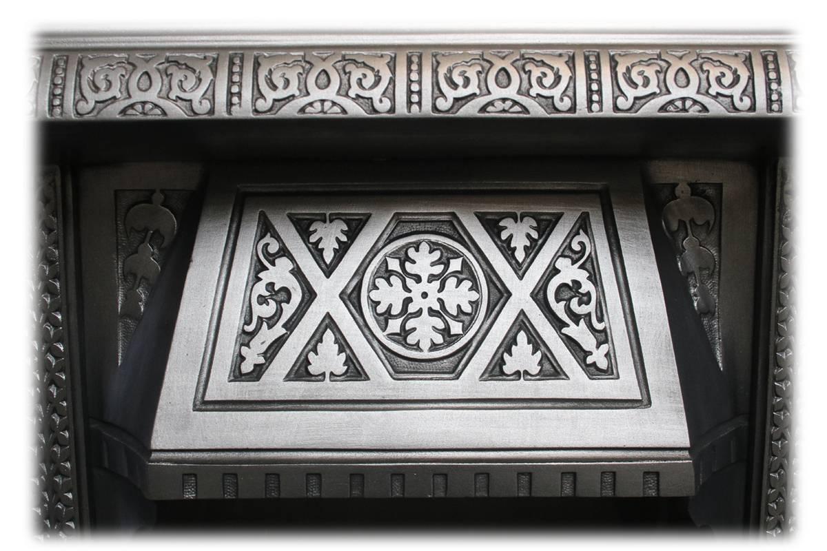 Restored antique Aesthetic cast iron fireplace insert, circa 1890. Complete with an original set of antique fireplace tiles.

This grate has been finished the traditional black grate polish, leaving a gun metal / pewter shine. Alternative finishes