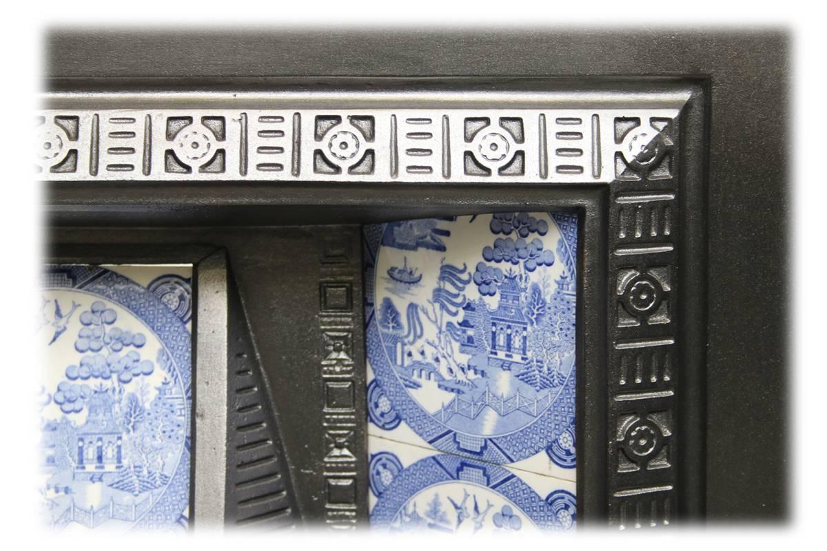Antique Victorian cast iron fireplace insert. Complete with an original set of antique fireplace tiles.

This grate has been finished the traditional black grate polish, leaving a gun metal / pewter shine. Alternative finishes are available,