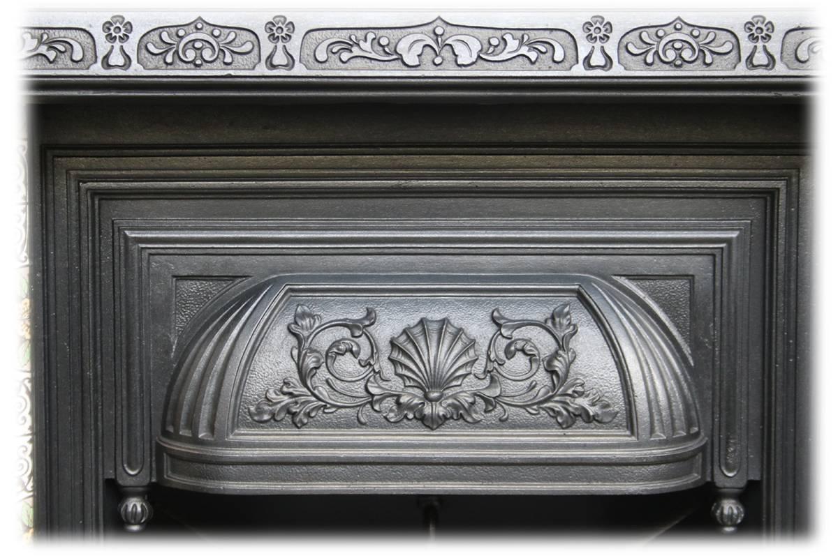 Pretty little 19th century cast iron fire insert. Complete with an original set of antique fireplace tiles.

This grate has been finished the traditional black grate polish, leaving a gun metal / pewter shine. Alternative finishes are available,