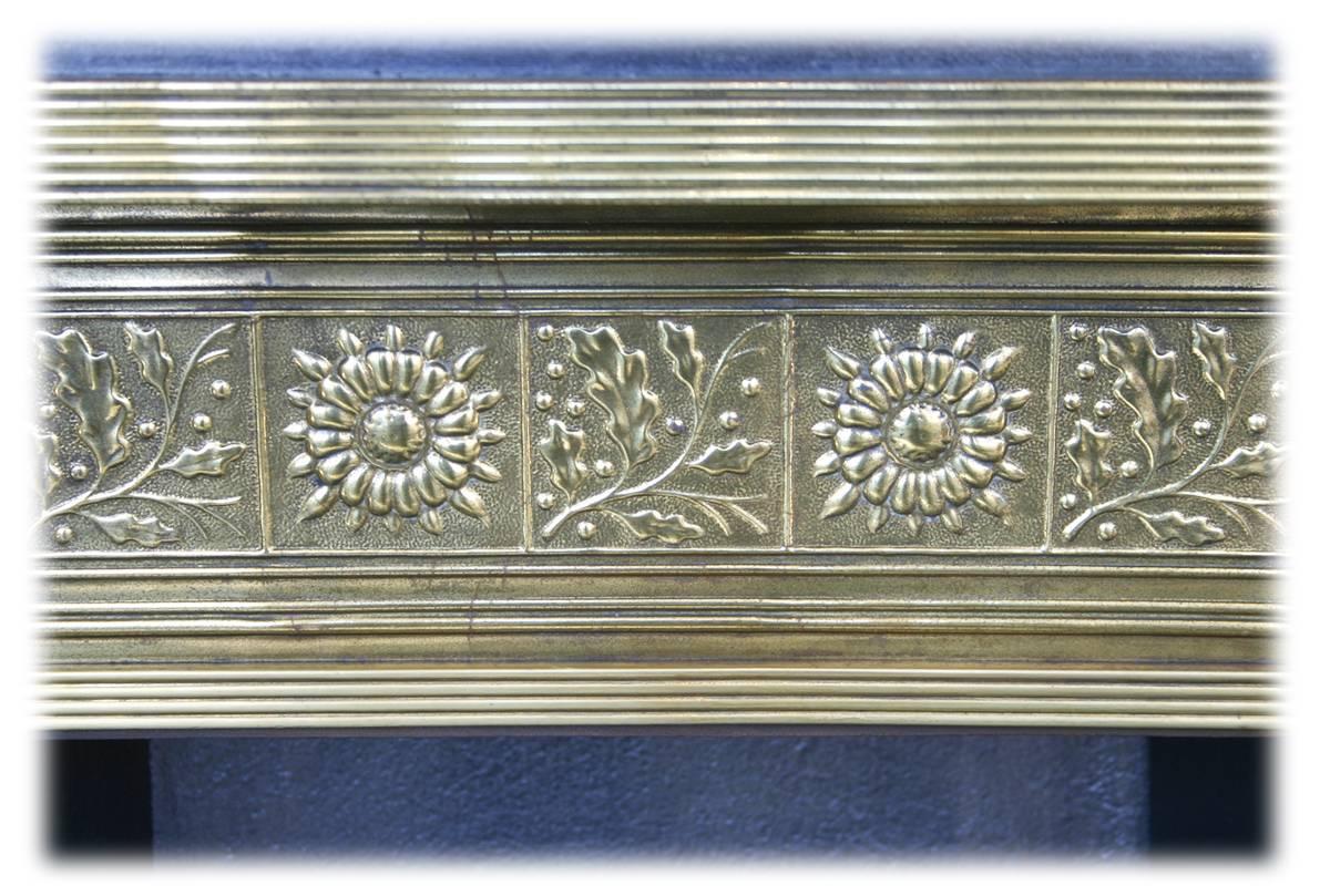 Antique late Victorian cast iron and grate in the Arts & Crafts manner with fine brass frame and brass repousse panel to the canopy. Complete with a beautiful set of antique fireplaces tiles.

This grate has been finished the traditional black