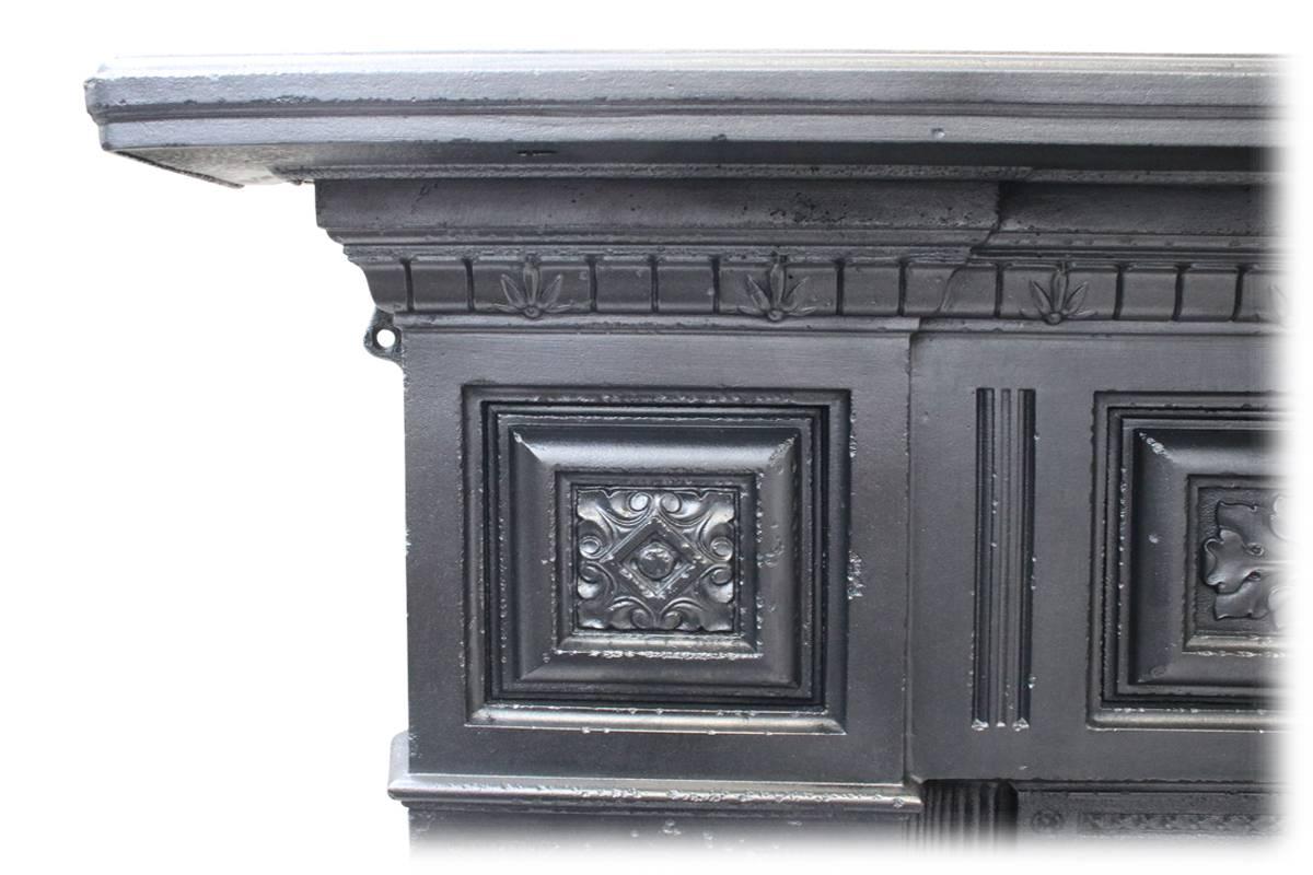 A large reclaimed antique cast iron fireplace, with fielded panels to the legs, frieze and capitals ornately cast with acanthus detail, circa 1880. 

Ready to be installed and used for a real coal or log fire this fireplace comes complete with