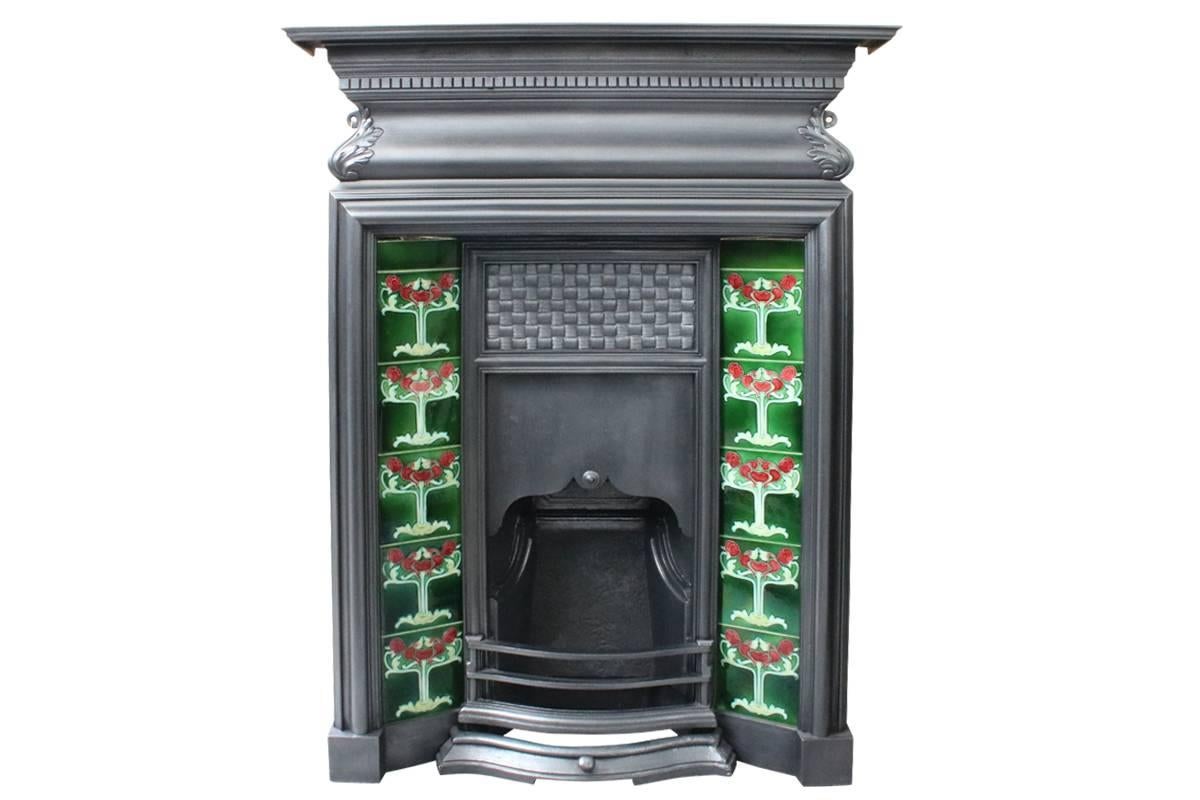 Elegant Edwardian cast iron combination grate with simple bolection mold to the surround below a cushion frieze with acanthus leaf detail. The canopy has finely cast basket weave detail and a sliding blower which can be lowered to assist the draw.