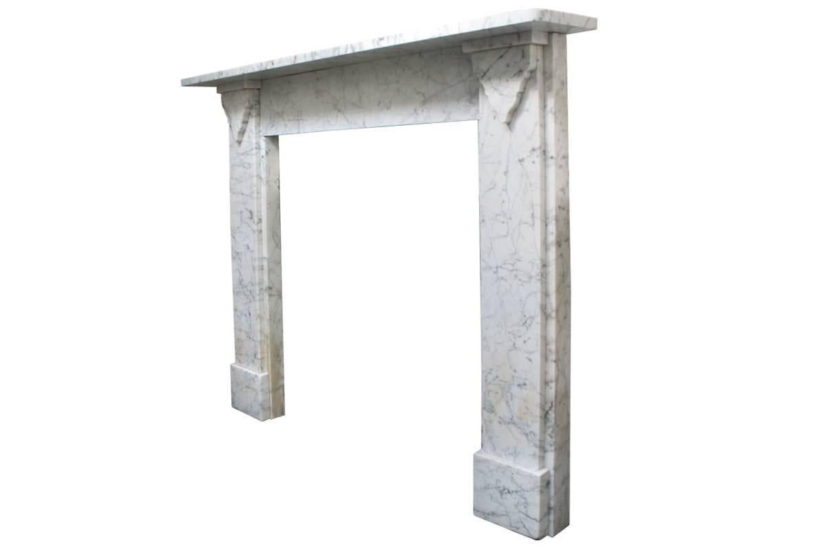 Restored mid-19th century Victorian Carrara marble fireplace surround with simple tapering brackets to the capital, circa 1850.