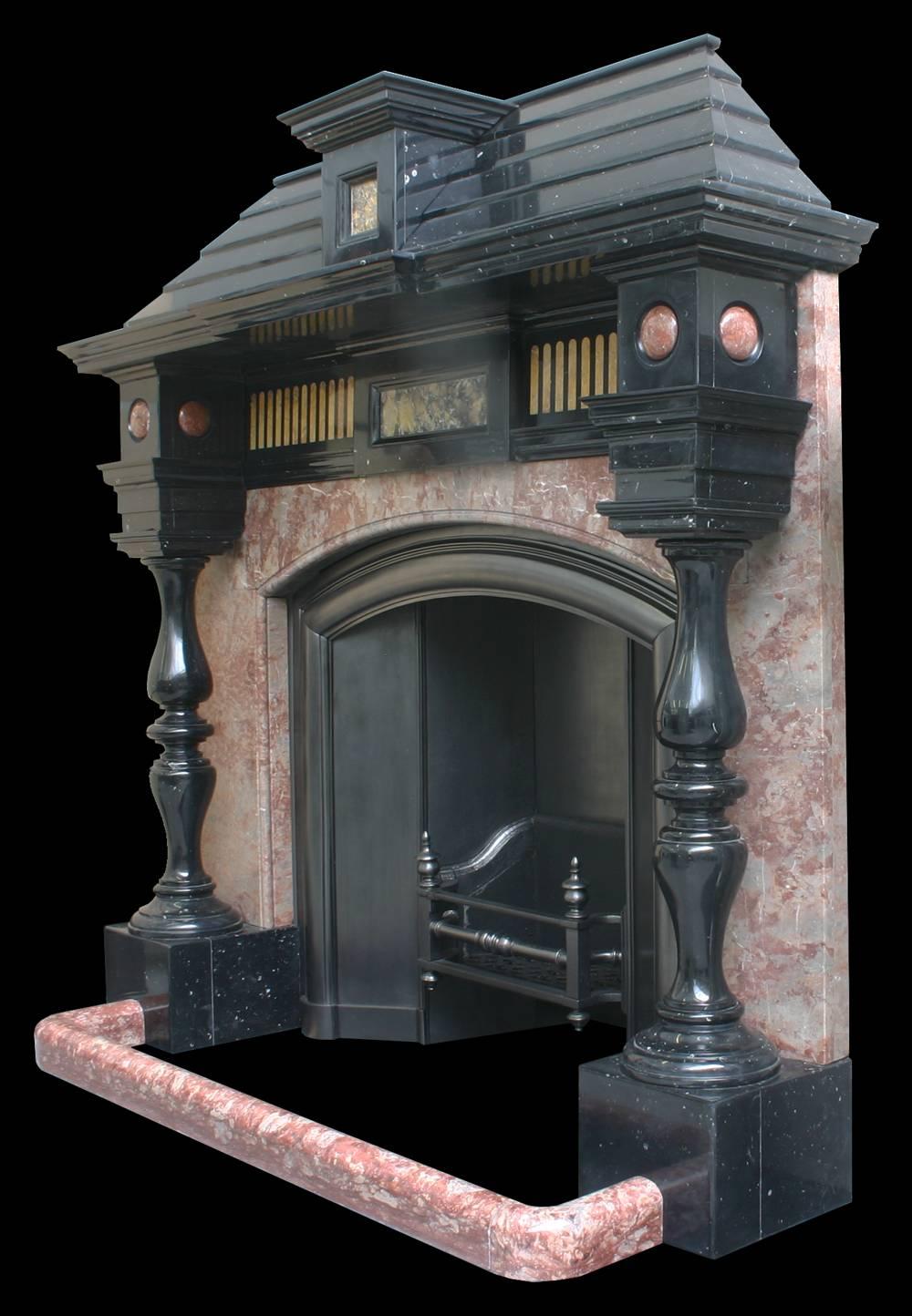 An unusual, large and very imposing architectural antique black marble chimneypiece in the Baroque manner, with baluster pillars in front of rosso verona marble panels supporting a frieze inlaid with Siena marble, all topped of with a black marble