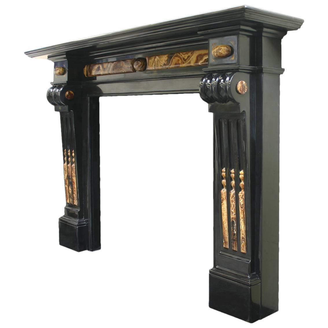 An unusual and imposing restored and polished Victorian Belgian black marble chimneypiece with carved corbels and fluted legs, the flutes decorated with onyx reeds. Onyx mounts and inlays to the frieze and capitals, circa 1890.

Measures: Shelf