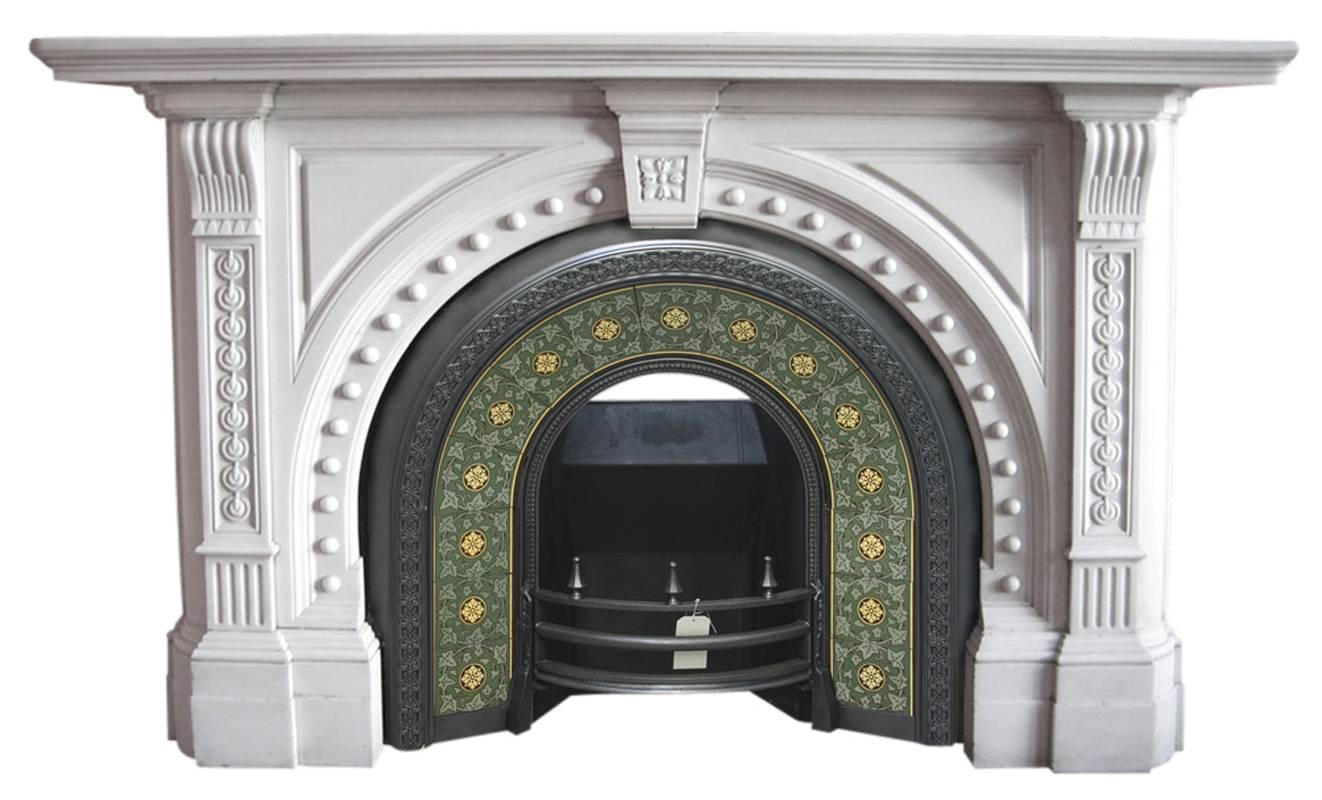High quality large antique late Victorian statuary marble fire surround with arched aperture. Finely carved corbels support the shelf,
English, circa 1870.
Images prior to restoration. This chimneypiece is awaiting restoration, lead time to