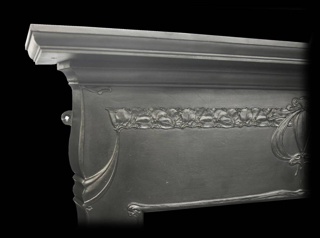 Fine antique Edwardian Art Nouveau cast iron fireplace surround finished with traditional graphite paste giving a lovely gun metal finish.
