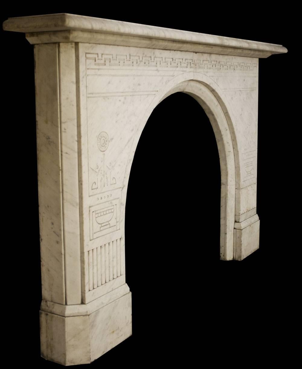 Unusual antique Victorian Carrara white marble fireplace with an arched aperture and fine aesthetic detail.

Images prior to restoration. This chimneypiece is awaiting restoration, please enquire as to the lead time to complete the restoration