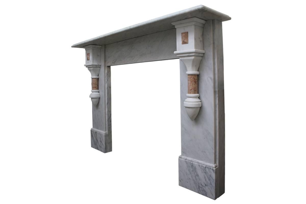 Large 19th century Victorian Carrara marble fireplace surround with crema Valencia demi pillars terminating in large square capital adorned with crema Valencia lozenges, circa 1880.
