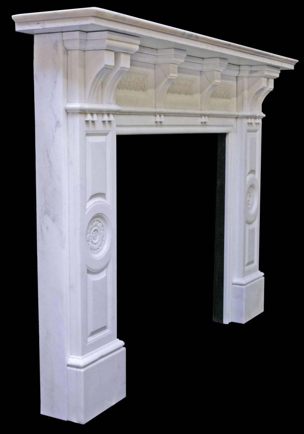Antique late Victorian statuary white marble chimneypiece with fielded panels to the legs centred by carved flowers, the frieze is decorated with flowers and guilloche carving. From a large villa in Bournmouth, United Kingdom. 

Shelf length: 74