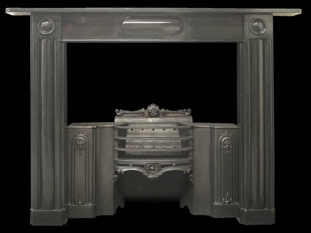Antique Georgian black marble fireplace surround, with fluted jambs terminating in square capitals with applied carved roundels. The frieze is centered with an oval plaque carved in high relief. The cast iron hob grate is sold separately, please