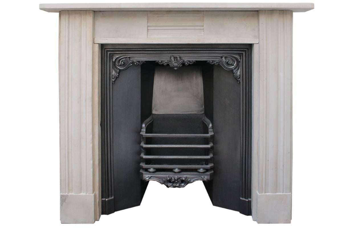 Antique Regency grey stone fireplace surround, with full fluted legs and breakfront frieze, circa 1820.