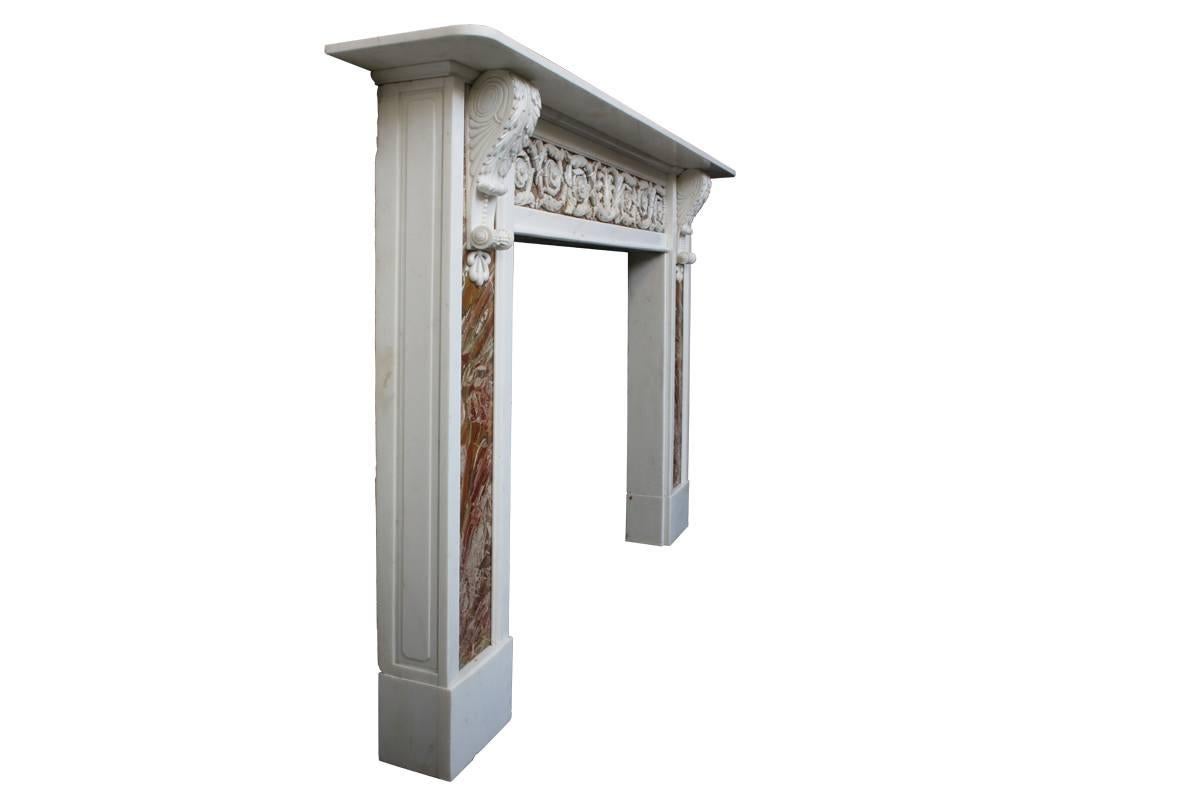 Rare and very large 18th century George III statuary white marble fire surround, the legs and frieze are inset with bookmatched panels of Sicilian jasper. The legs terminate with beautiful corbels carved with acanthus and anthemion detail, and the