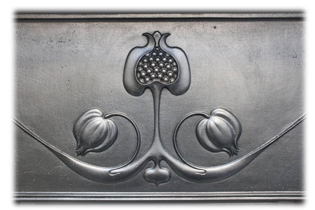 Antique Art Nouveau Edwardian cast iron and tiled combination grate. Flowing tendrils emanate from stylized pomegranate fruits in the centre of the frieze, above an adjustable canopy. Dated 1905. Complete with a set of original antique fireplace