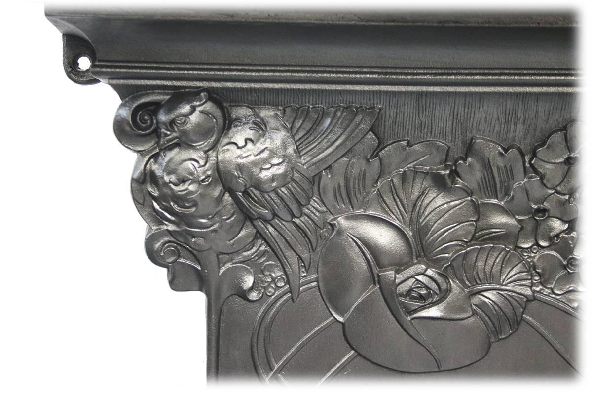Very large spectacular Edwardian Art Nouveau cast iron and tiled combination grate. The frieze cast with stylized flowers including roses and hydrangeas. Perched in the corners amongst these flowers are two birds. Flowing tendrils synonymous with