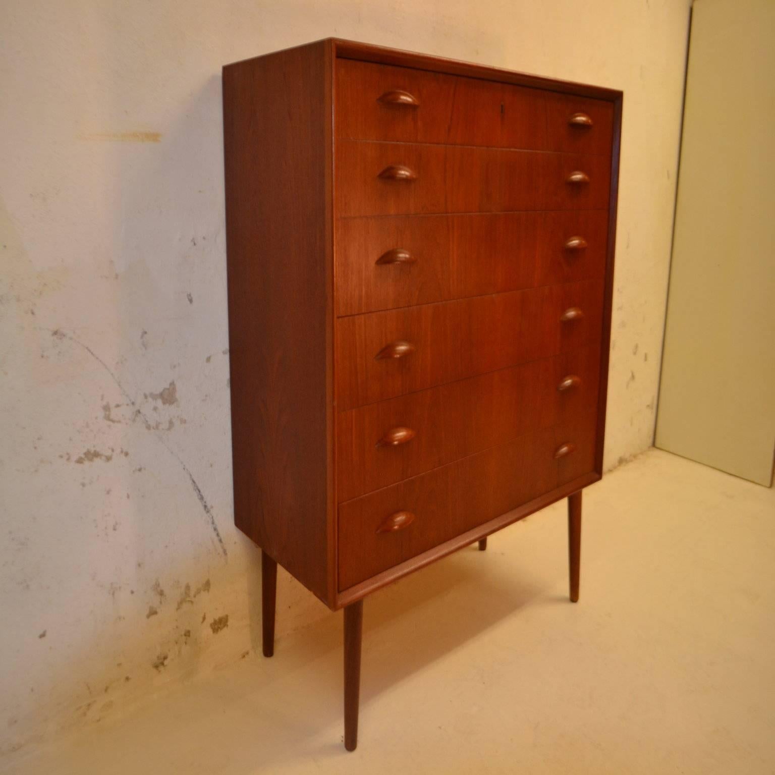Danish teak chest of drawers designed by Kai Kristiansen, Denmark.

The chest has six drawers with elegant shaped wooden handles.

Free UK Mainland delivery.

Worldwide shipping available - please contact us for a quote.