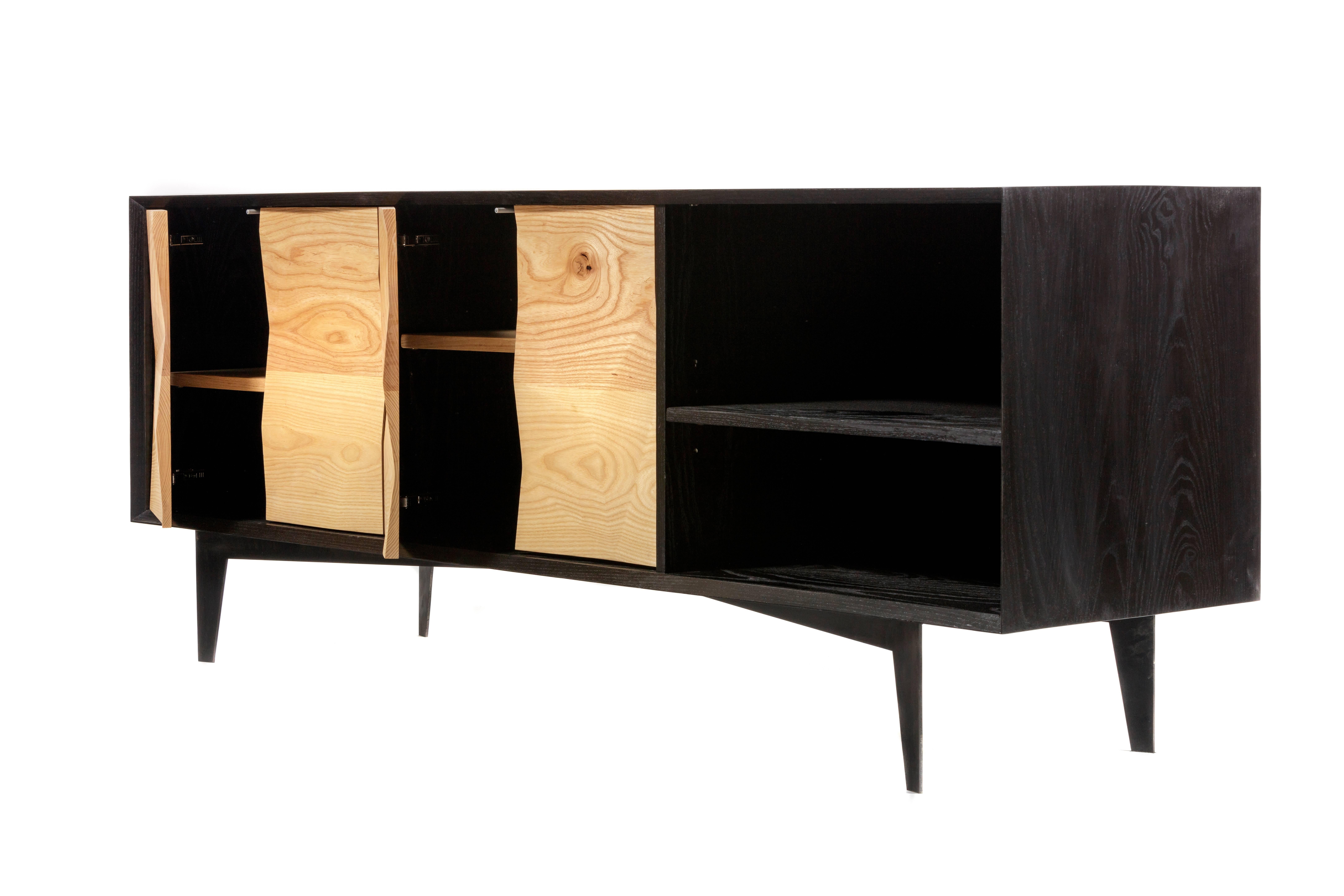 Our Westchester credenza was derived from the variations of ice crystals on Westchester Lagoon in southeast Alaska. The ebonized ash credenza incorporates custom fabricated ash doors to mimic the variations and complexities of natural surfaces. The